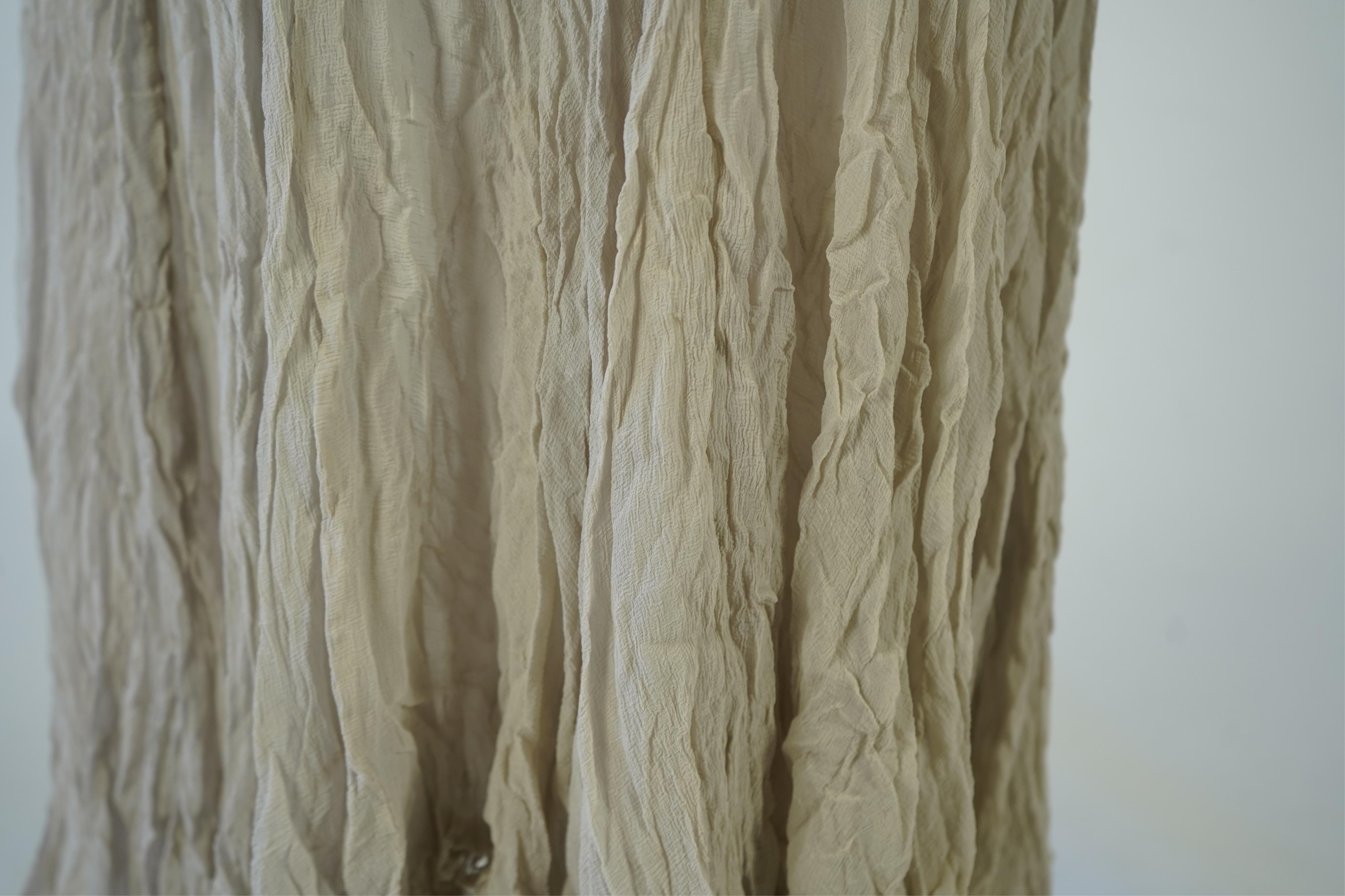 A 1930's grey chiffon bias cut ladies evening dress. 120cm long. Condition - has a small hole at the back and a light mark possibly removed with washing.